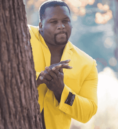 black-guy-hiding-behind-tree